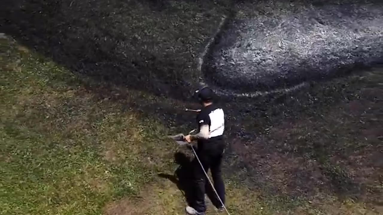 Artist Saype creating art in nature using biodegradable painting he made himself