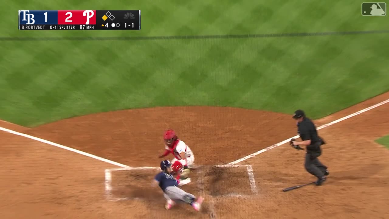 Phillies Bryson Stott throws out runner at home plate, Aramis Garcia with the tag