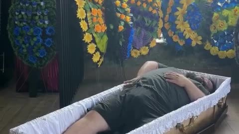 A plump Ukrainian decided to try on a coffin for size. And got stuck in it.