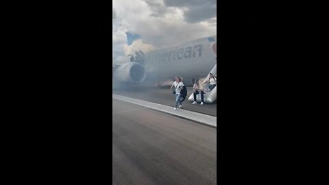 Passengers flee smoking jet on emergency slide at Denver airport