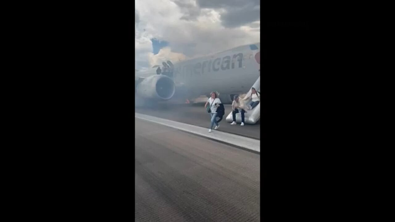 Passengers flee smoking jet on emergency slide at Denver airport