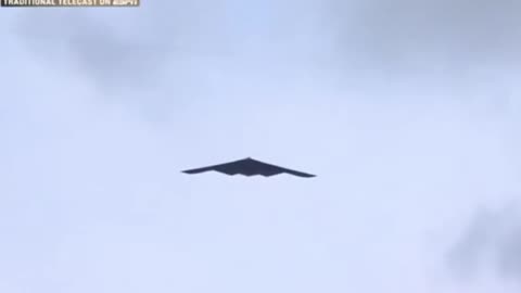 A B-2 BOMBER MERGED FROM THE CLOUDS OVER THE ROSE BOWL Y