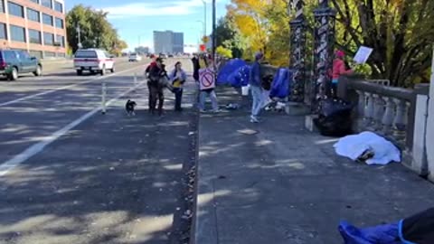 No Kings protesters walking past Portland’s homeless