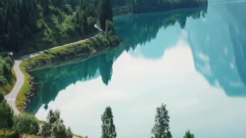 Idyllic Norwegian village on the shores of Lake Lovatnet. Nature 4K videos