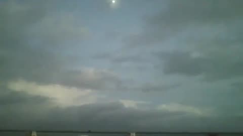The moon, sky, boats and sea, being filmed at nightfall, in a beautiful view [Nature & Animals]