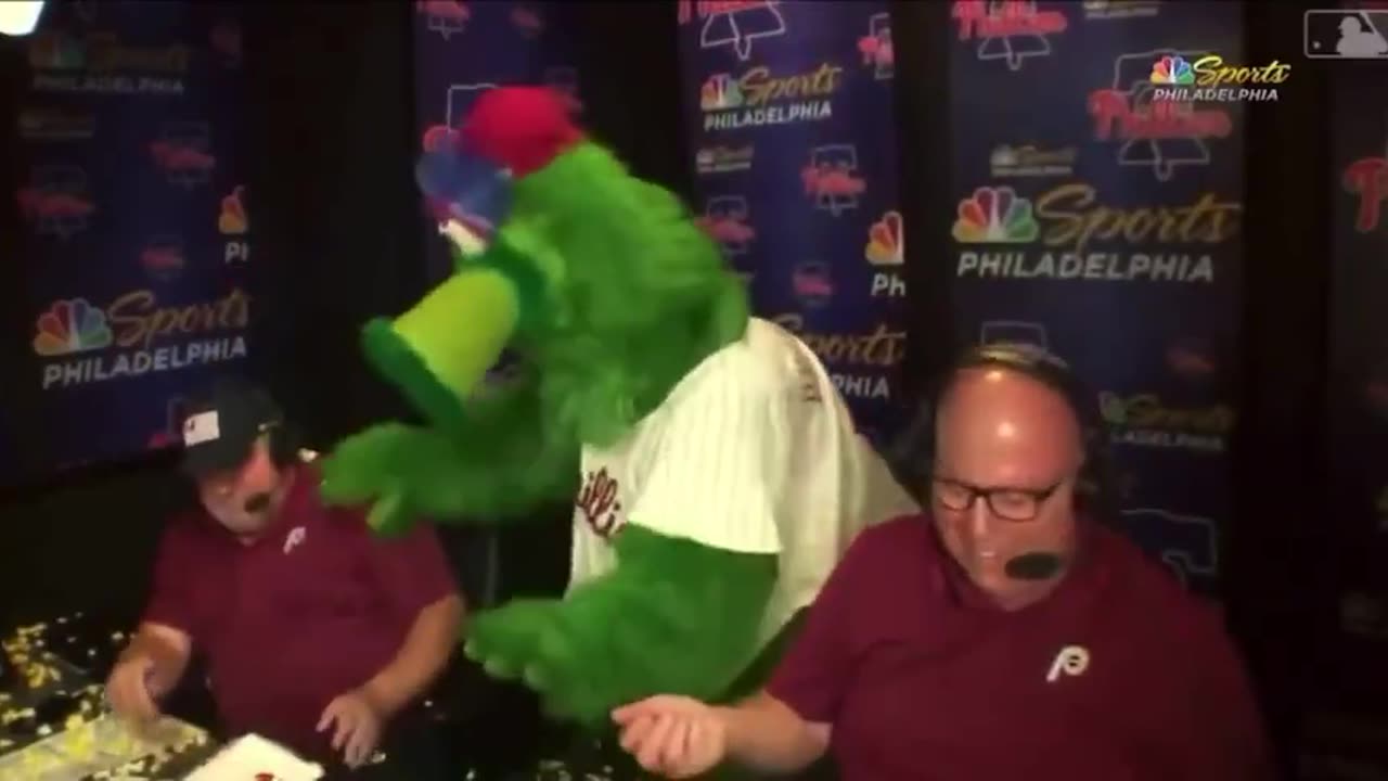 Philly Fanatic spills popcorn on John Kruk and Tom McCarthy in the booth