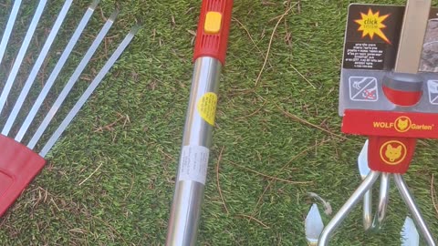 Wolf Garden gardening tool set, including a pole, broom, cultivator, rake, hand rake, branch pruner.