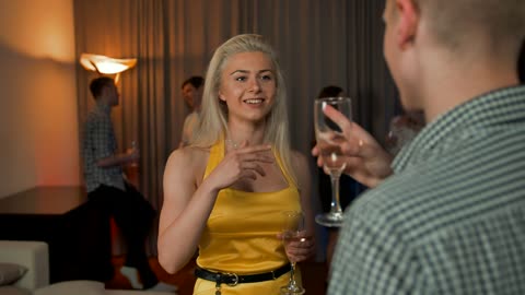 Young blonde woman chatting with a man.
