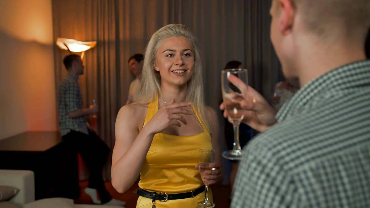 Young blonde woman chatting with a man.