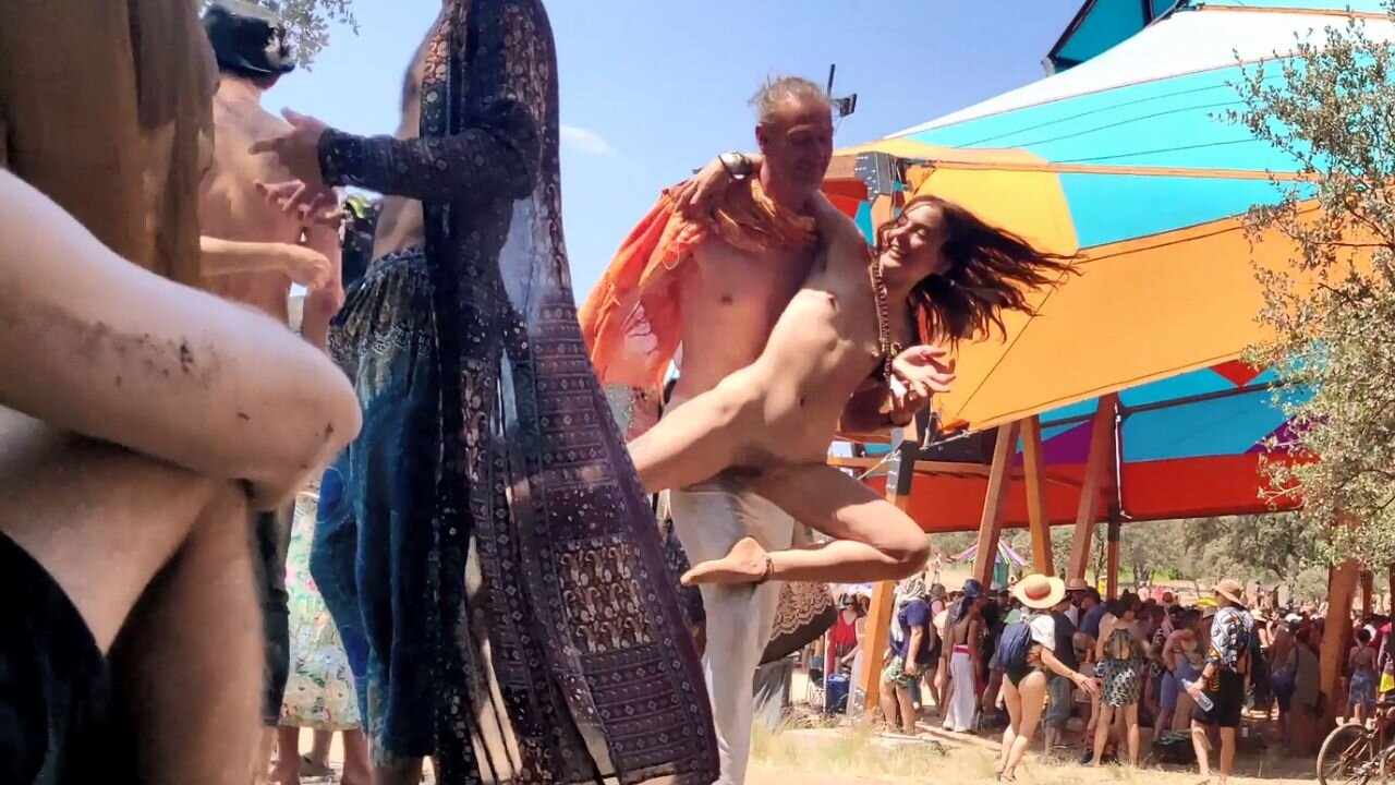 Redhead naked girl dancing wildly at festival