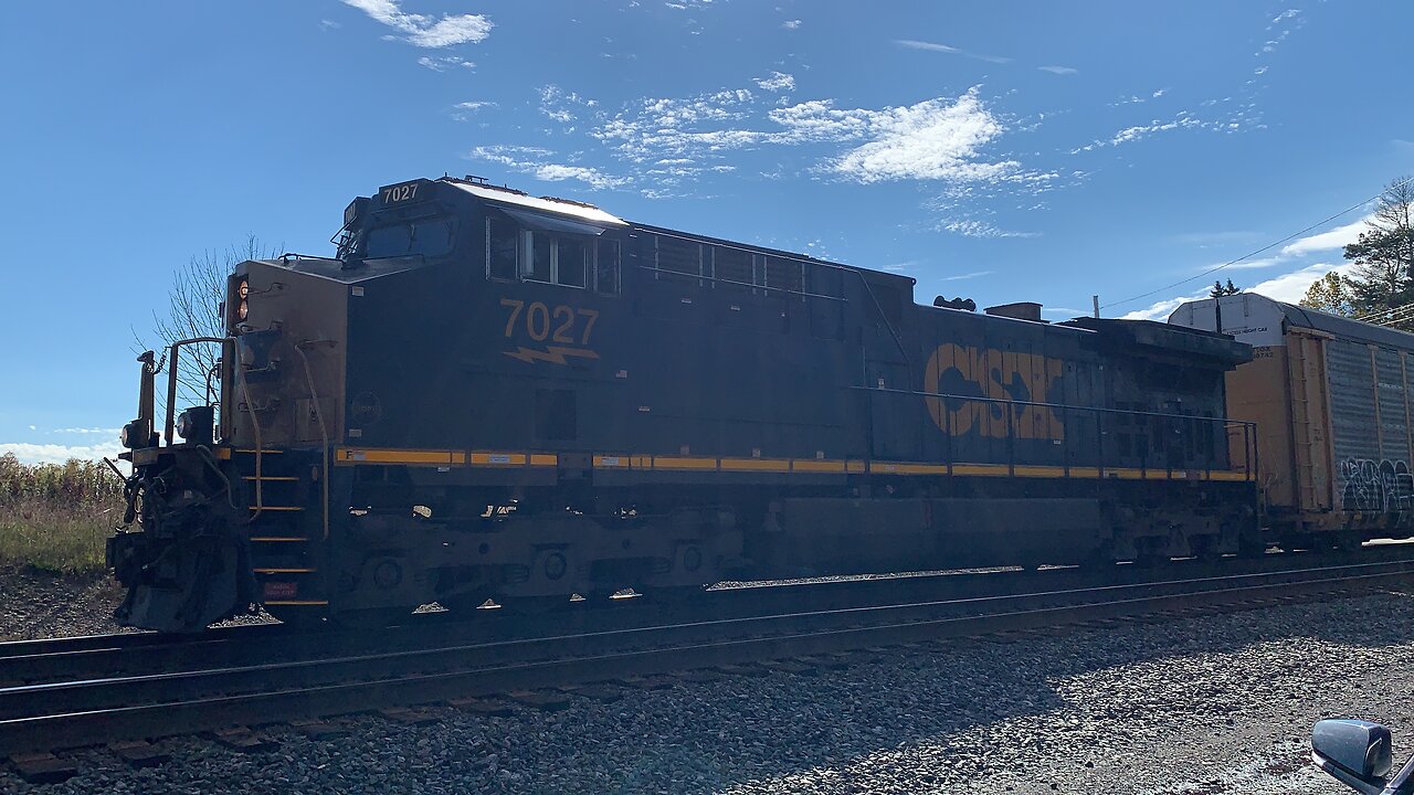 CSX train engine 7027 leads a train East with DPU 3273