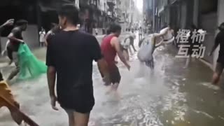 #Macau streets — now residents are wading in and catching fish like it’s a giant pond. #typhoon
