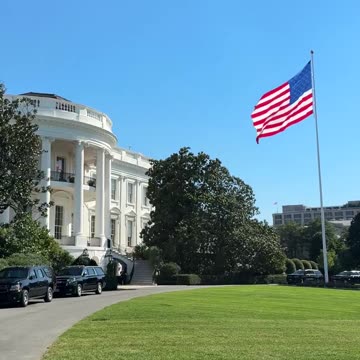 That flag makes the White House look so beautiful.