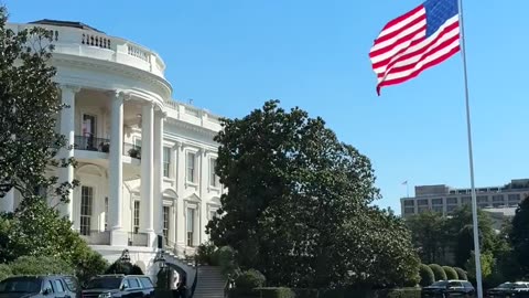 That flag makes the White House look so beautiful.