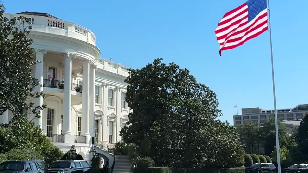 That flag makes the White House look so beautiful.