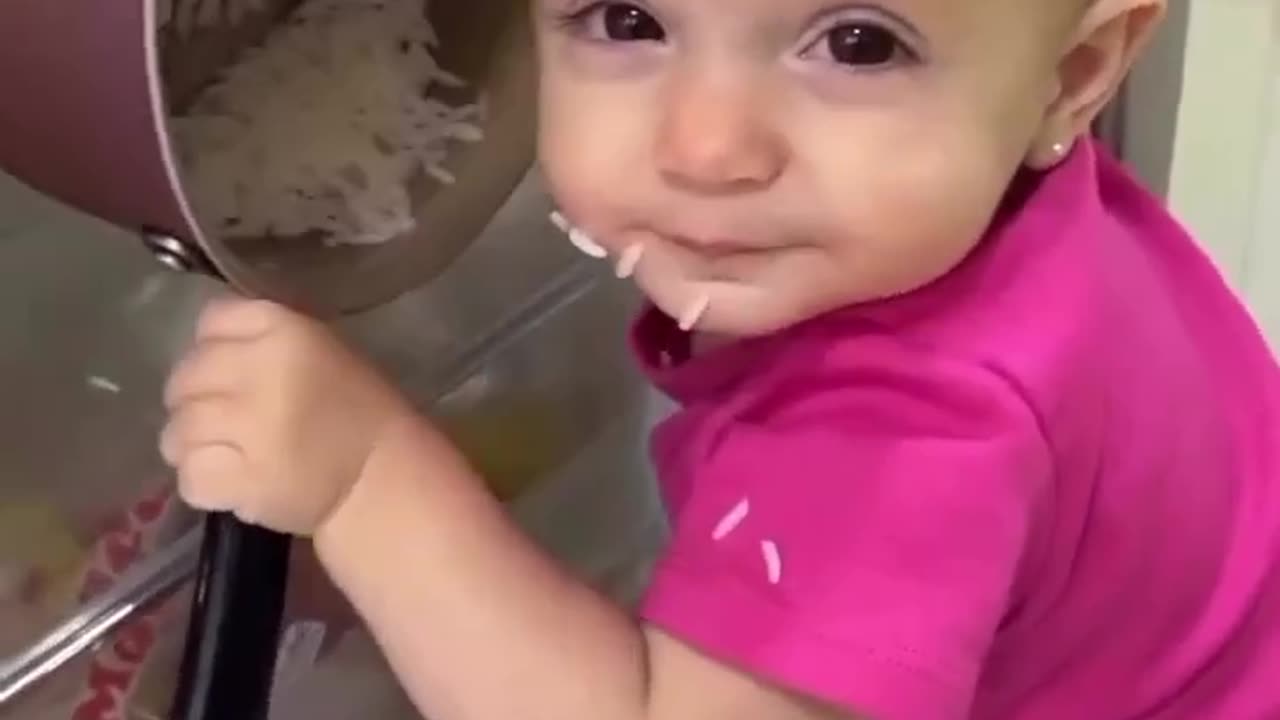 A cute little baby is stealing food from the fridge