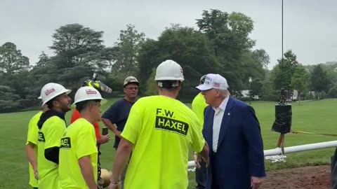 President Donald J. Trump walks out onto the South Lawn to meet with the men installing the new flagpole at the White House.