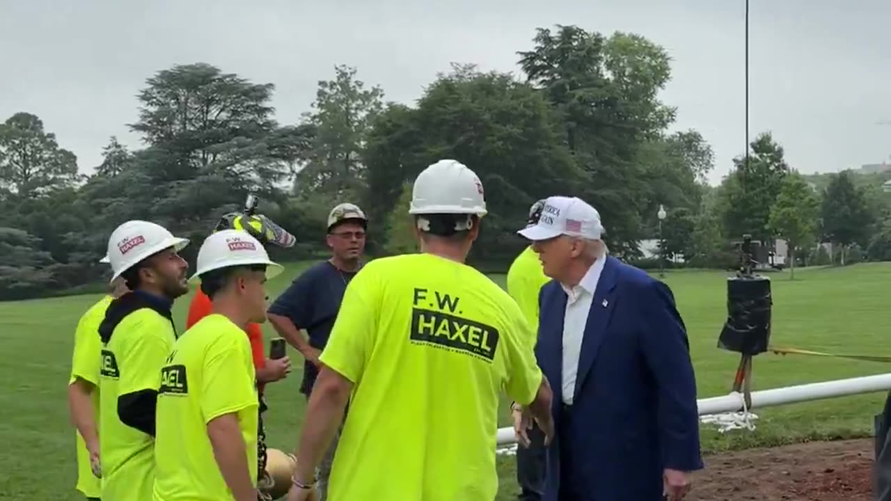 President Donald J. Trump walks out onto the South Lawn to meet with the men installing the new flagpole at the White House.