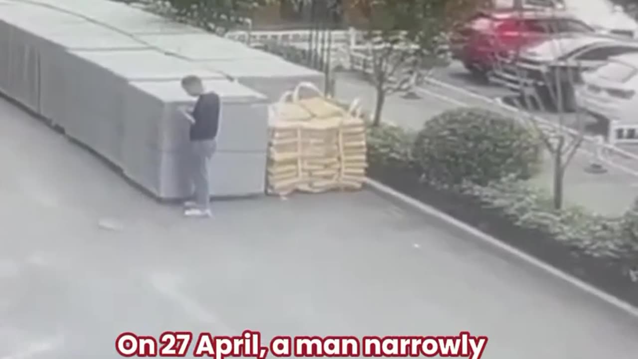 Brush with Death: Man Evades Falling Crane Boom in Dramatic Scene.