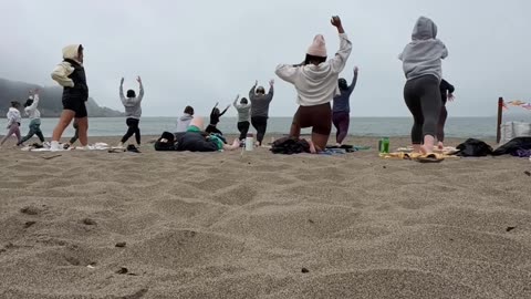 Man Takes a Nap During Sunday Morning Beach Yoga