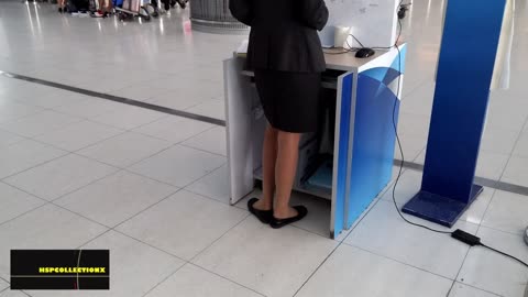 Dipping behind her work station...