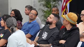 A group of Americans are given a presentation about integrating foreigners