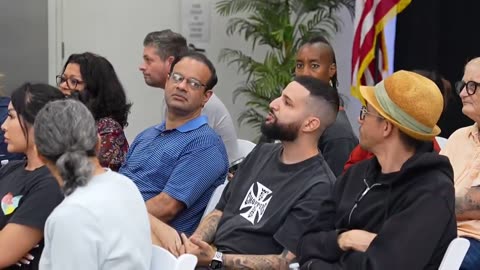 A group of Americans are given a presentation about integrating foreigners