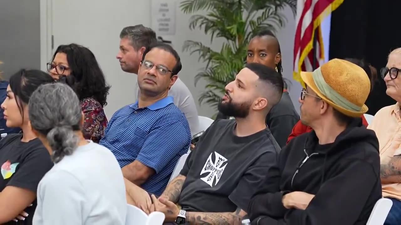 A group of Americans are given a presentation about integrating foreigners