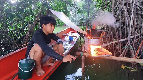 Lonely camping in the river , making tent and cooking delicious food for dinner