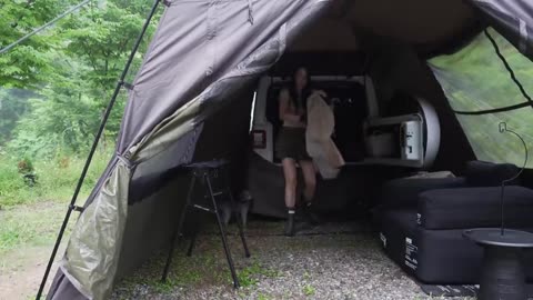 Rainy Forest Camping by a young beautiful girl while all alone with her Puppy
