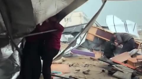 Footage shows displaced families’ tents and belongings being swept away by strong winds