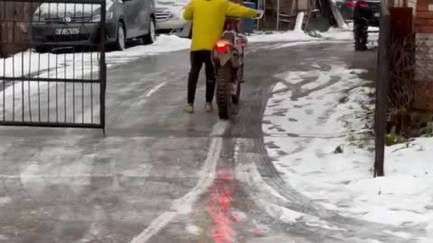 Motorcycle Slides Up Slippery Road