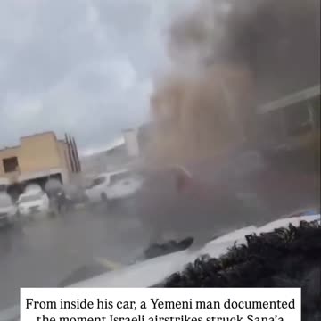 A Yemeni man films from his car as Israeli airstrikes pound the capital in broad daylight