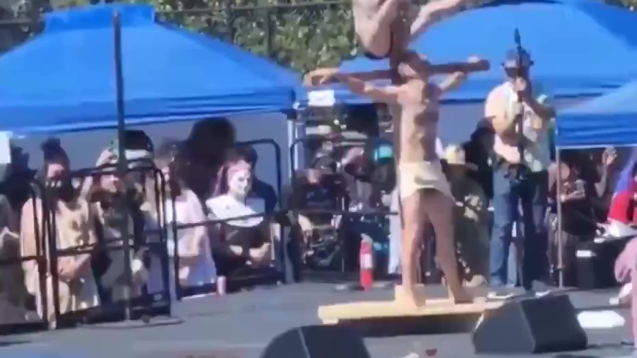 Man in skirt, bra and stilettos does lap dance on Jesus Christ. Abominable "spectacle".