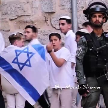 An 1$raeli child makes a sinister THROAT-CUTTING gestures