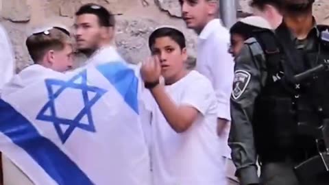 An 1$raeli child makes a sinister THROAT-CUTTING gestures