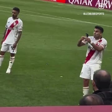 Marcos Acuna showing Denzel Dumfries his shin pad with the World Cup trophy