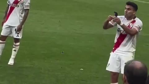 Marcos Acuna showing Denzel Dumfries his shin pad with the World Cup trophy