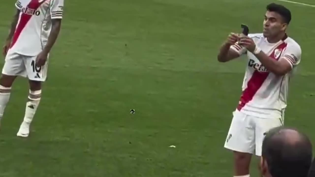 Marcos Acuna showing Denzel Dumfries his shin pad with the World Cup trophy