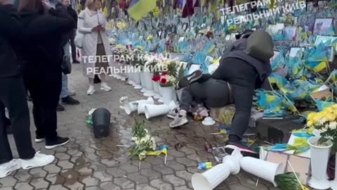 Heroes' Alley in Kyiv — Fight by Portraits of Fallen Soldiers. Man Chokes Woman. Considered Normal