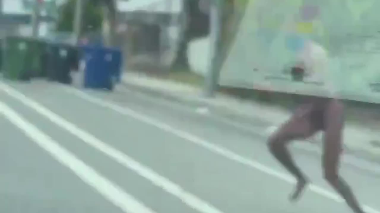 Naked migrant jumped on top of a moving car.
