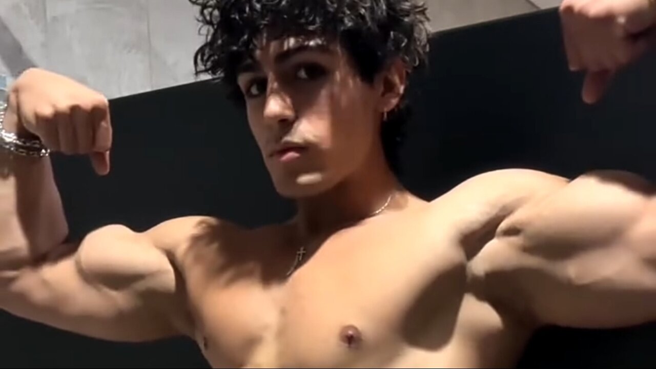 Young bodybuilder flexing muscles