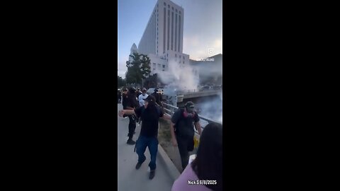 Rioters try injuring police by throwing large rocks off a bridge in their direction
