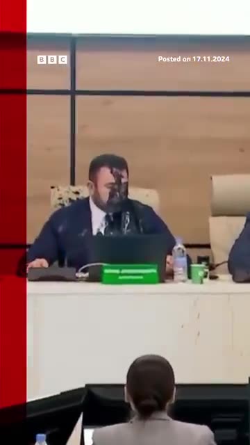 Moment Georgia election cheif doused in paint by opposition official