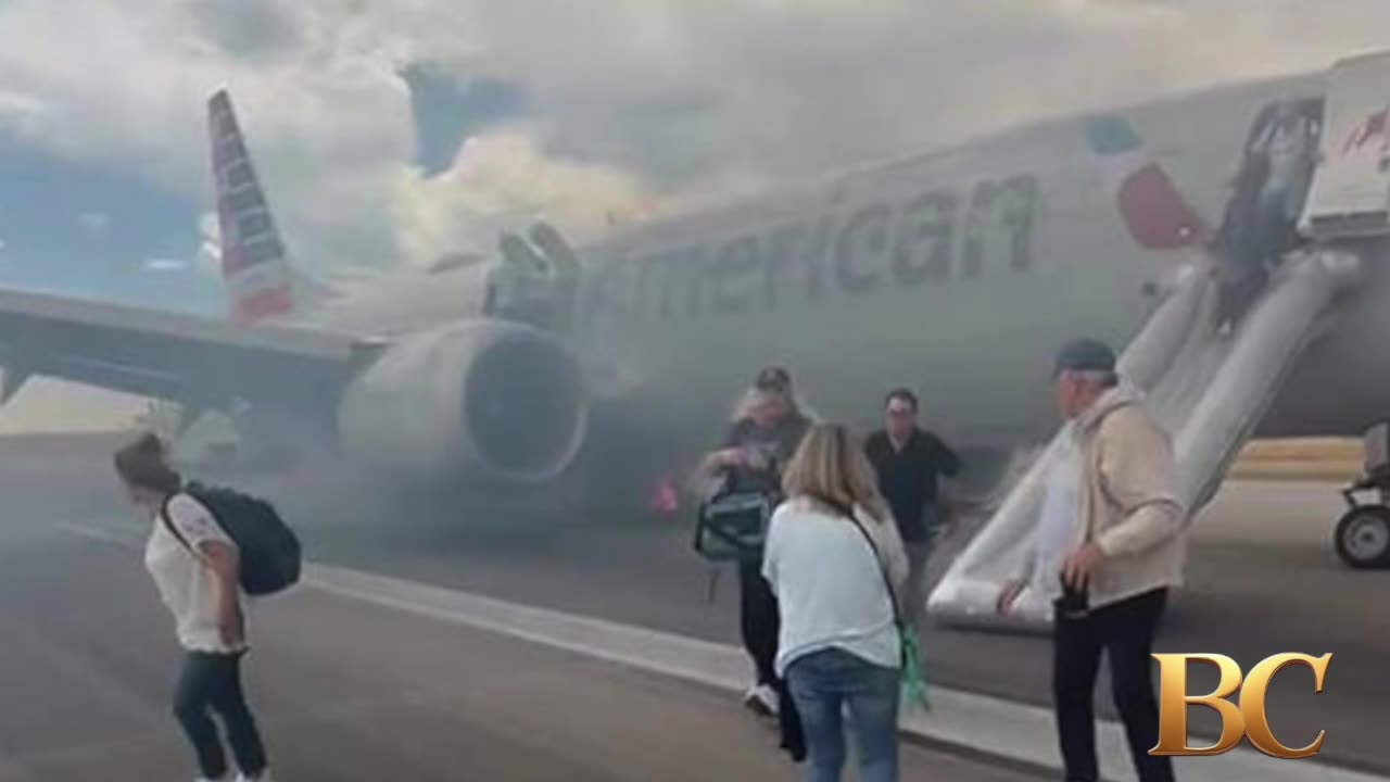 Passengers exit plane via emergency slide after aborted takeoff