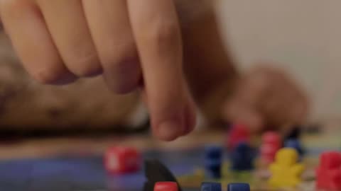 Girl moving small figures from a board game
