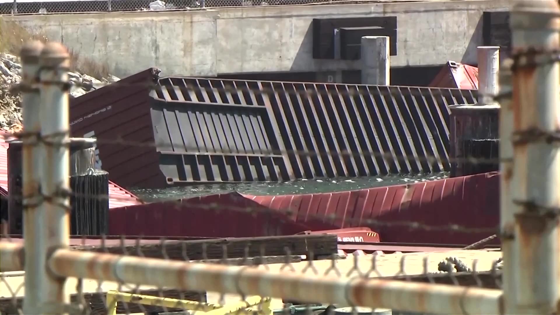 Dozens of shipping containers tumble into water at California port
