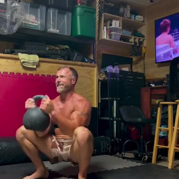 Guy's doing kettlebell exercises