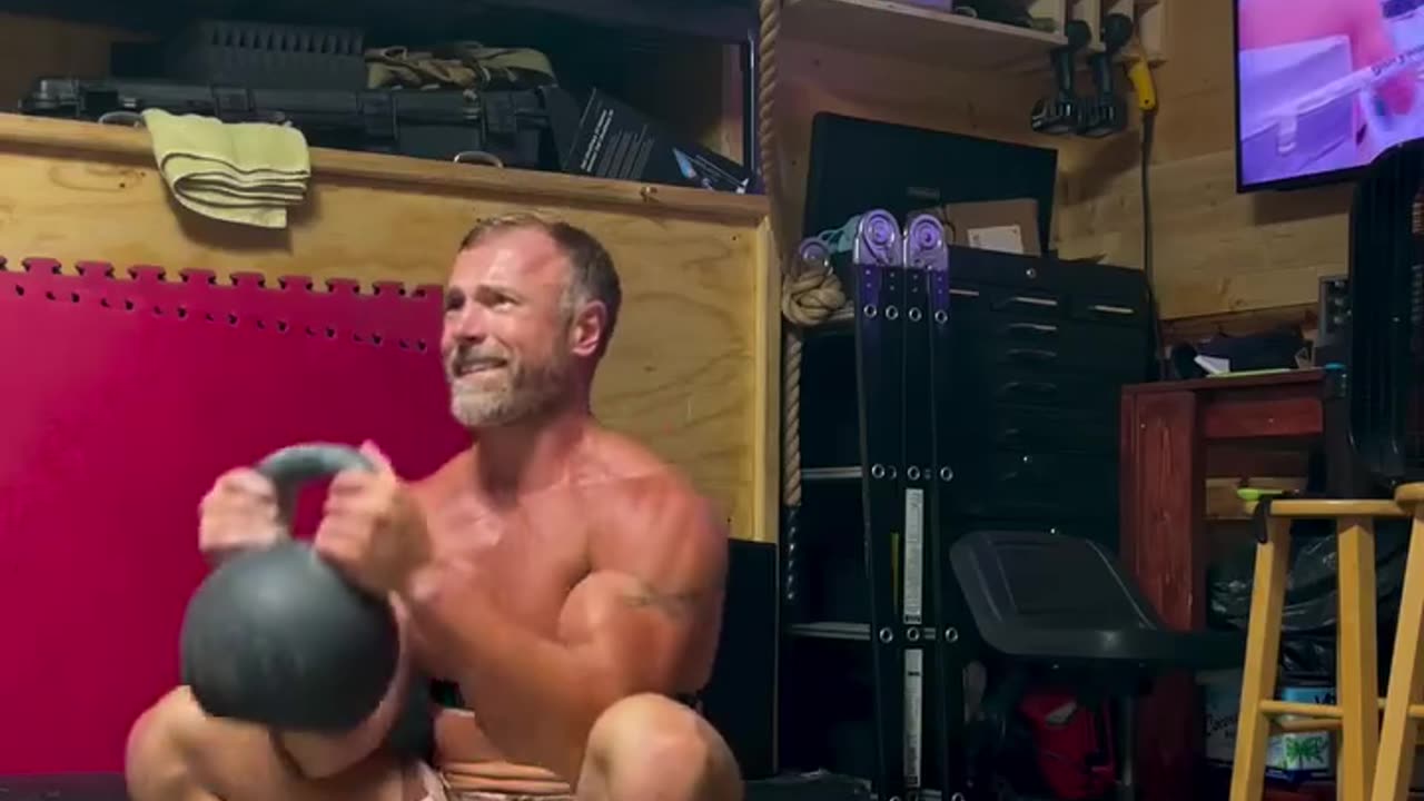 Guy's doing kettlebell exercises