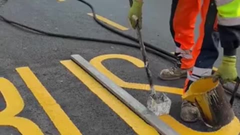 Road letters being painted in the UK